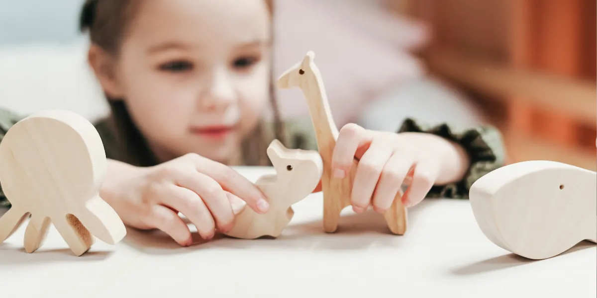 A girl playing with wooden toys